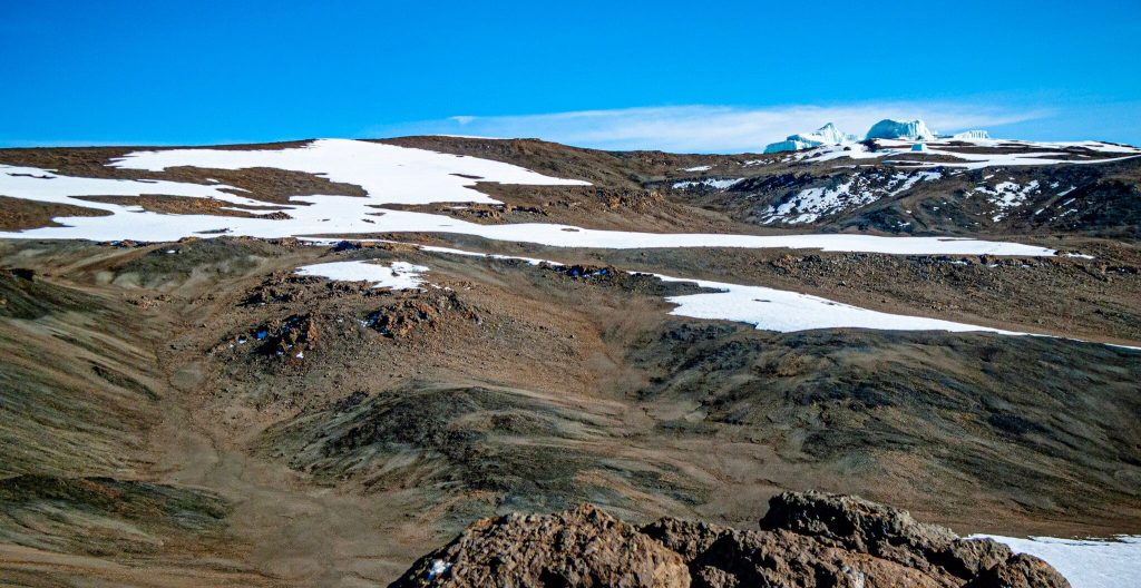 Snowfields and distant glacier ice cliffs on the southern side of Mount Kilimanjaro