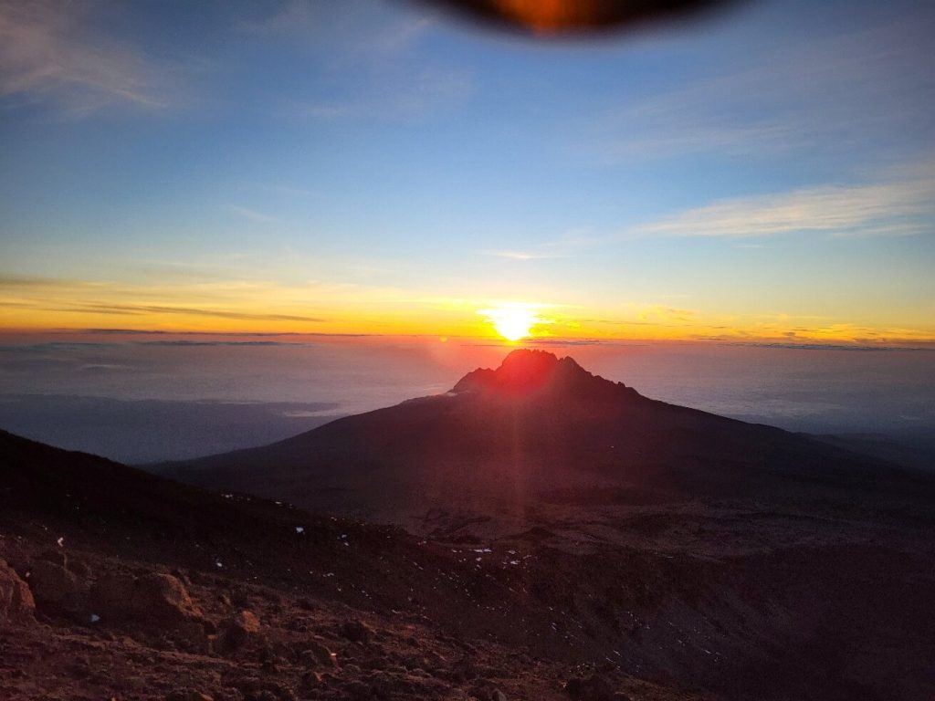 Sunrise behind Mawenzi peak seen from a scree slope on the northern Rongai approach