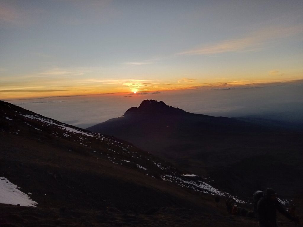 Sunrise over the jagged peak of Mawenzi above a sea of cloud on Mount Kilimanjaro