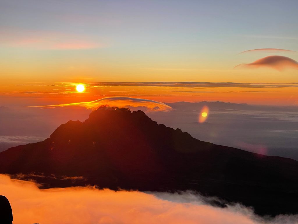 Sunrise over a jagged peak above a sea of cloud on Mount Kilimanjaro